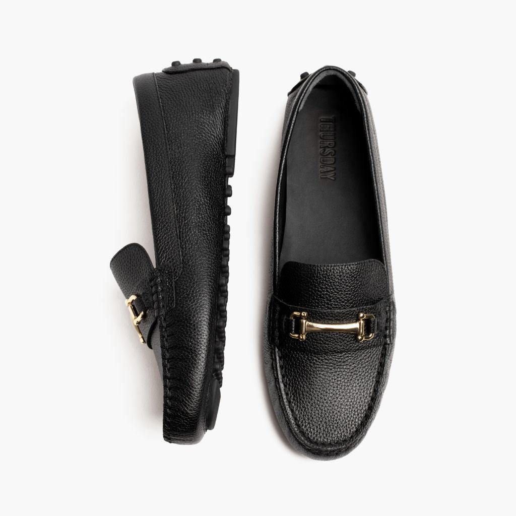 https://cdn.shopify.com/s/files/1/0419/1525/files/1024x1024-Women-DrivingLoafer-BlackGold-062524-Flatlay1.jpg?v=1757957628