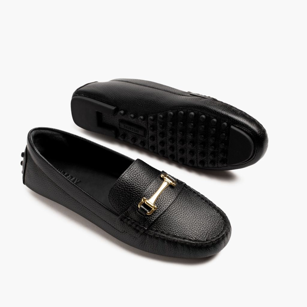 https://cdn.shopify.com/s/files/1/0419/1525/files/1024x1024-Women-DrivingLoafer-BlackGold-062524-FlatlayAlt.jpg?v=1757957628