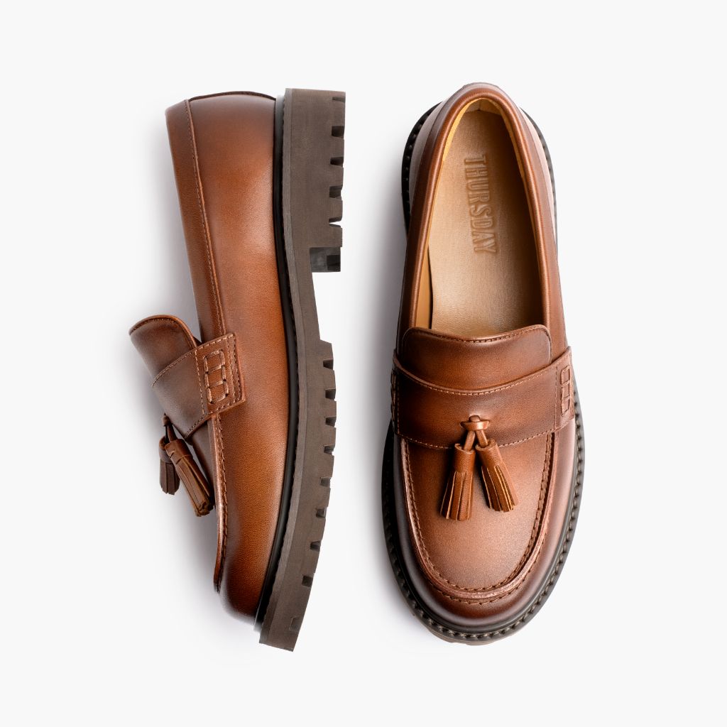 https://cdn.shopify.com/s/files/1/0419/1525/files/1024x1024-Women-TasselPenny-Toffee-012226-Flatlay1.jpg?v=1771869475