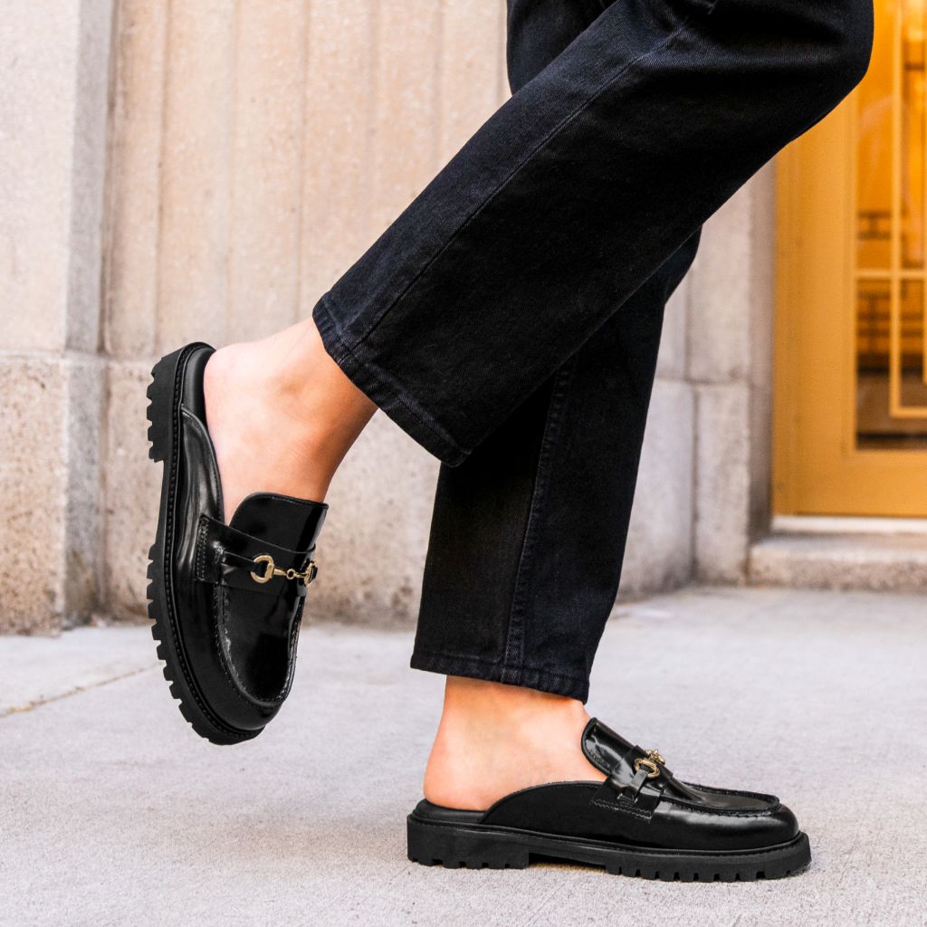https://cdn.shopify.com/s/files/1/0419/1525/files/1024x1024-Womens-PennyMule-BlackGold-102524-2_51ba10e4-6ad2-4038-9e45-2b32709d71a9.jpg?v=1730318490